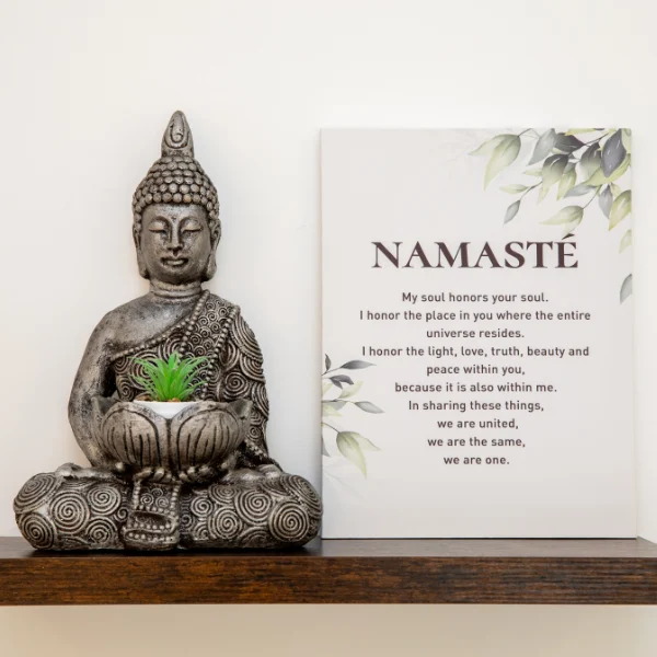 Photo of a buddha statue and sign that says namaste