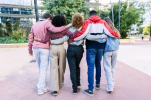 Group of people walking arm in arm to represent peer support in recovery in Fairfax, VA.